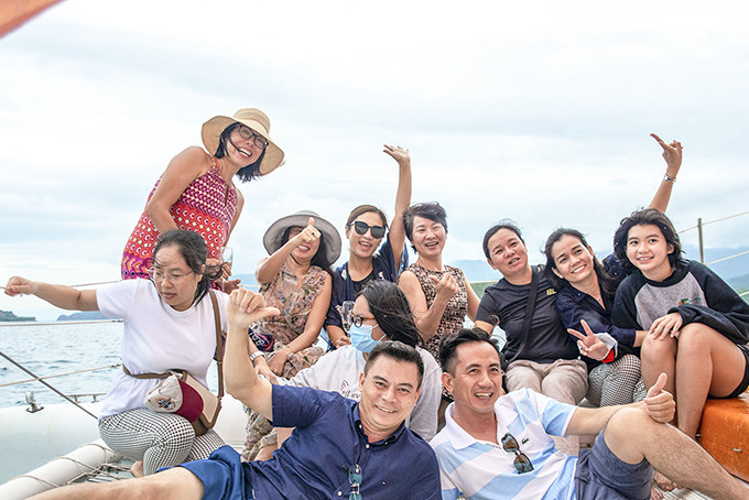 Tourists posing when taking tour on Nha Trang Bay Catamaran sailing boat