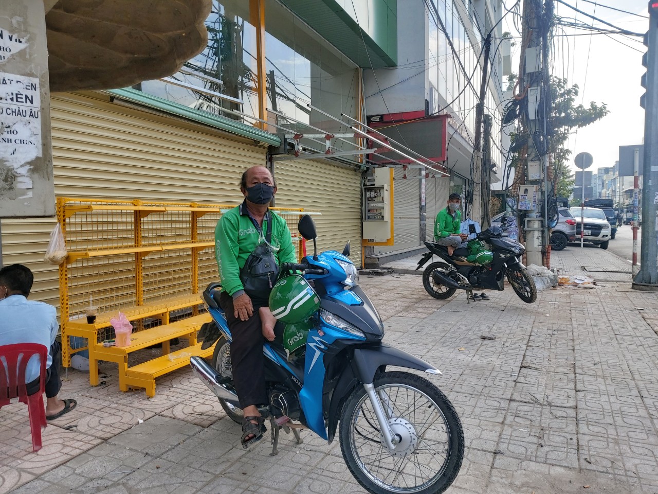 Motorbike taxi drivers keep a distance of two meters