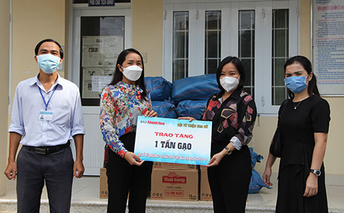 Lãnh đạo Báo Khánh Hòa (thứ ba từ trái qua) và đại diện Hội từ thiện Hoa Sứ tặng quà cho người dân phường Vĩnh Hòa.