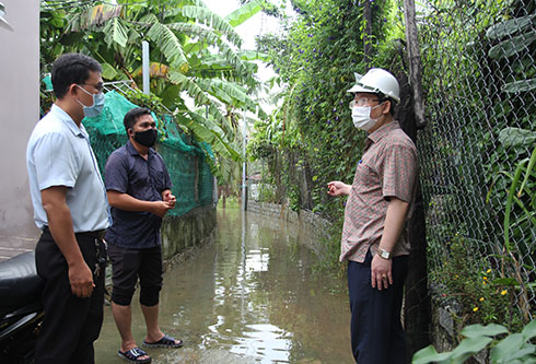Đoàn công tác của UBND TP. Nha Trang kiểm tra một đường hẻm bị ngập ở xã Vĩnh Thái. 