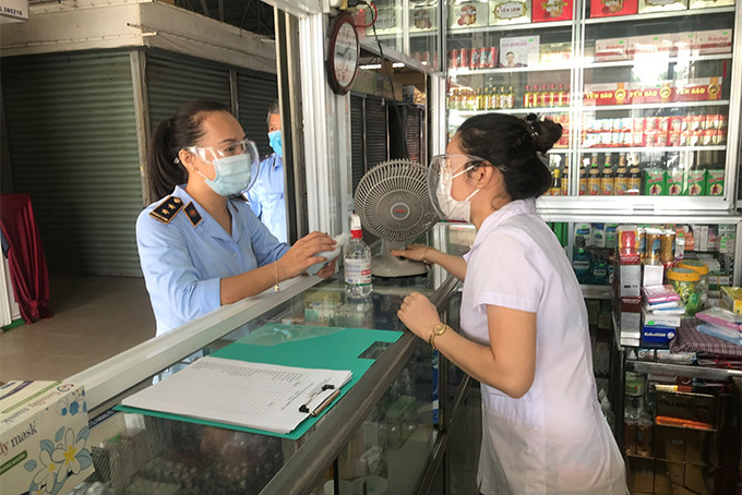 Lực lượng quản lý thị trường kiểm tra mặt hàng y tế phục vụ phòng dịch tại một quầy thuốc tây ở Nha Trang.