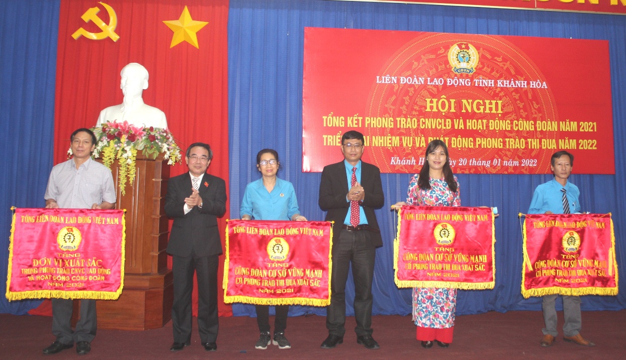 Ông Lê Hữu Trí và lãnh đạo Liên đoàn Lao động tỉnh trao cơ thi đua xuất sắc của Tổng Liên đoàn Lao động Việt Nam cho các tập thể.