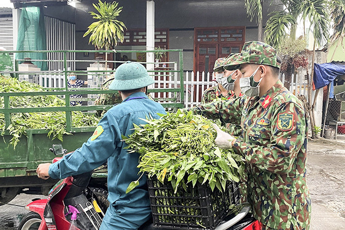 Lực lượng đoàn viên, thanh niên của trường tham gia phân phối lương thực, thực phẩm đến người dân khu vực cách ly phòng, chống dịch Covid-19. 