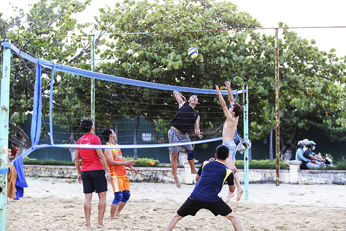 Playing beach volleyball