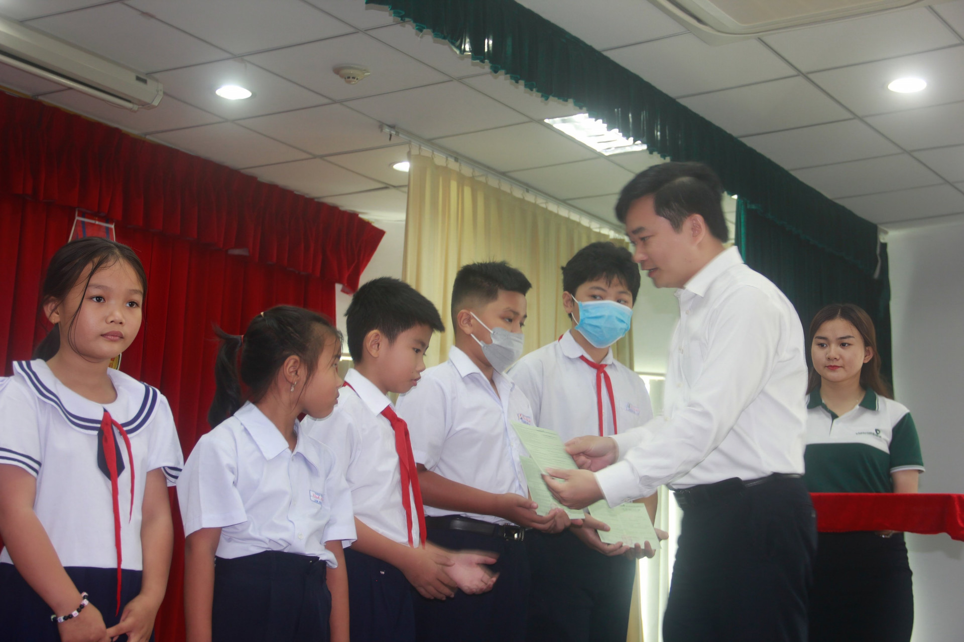 Đại diện Ngân hàng thương mại Cổ phần Ngoại thương Việt Nam chi nhánh Khánh Hoà  tặng sổ tiết kiệm cho trẻ.