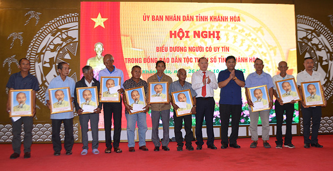 Ông Y Thông và ông Nguyễn Anh Tuấn tặng quà của Ủy ban Dân tộc cho người có uy tín.