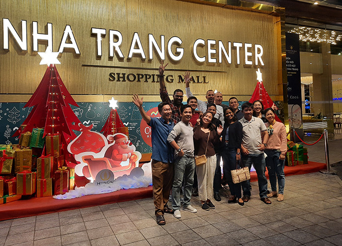 Tourists posing for photo in front of Nha Trang Center