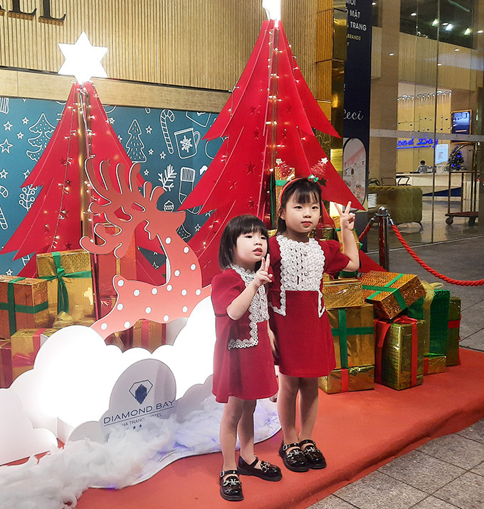 Two little girls dressing in red posing for photo